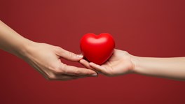 Hands with a red apple