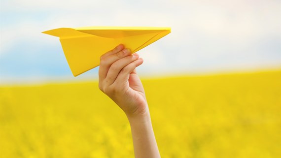 child throwing plane