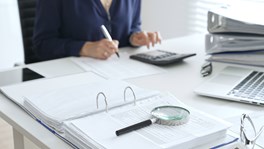 magnifying glass inspecting documents
