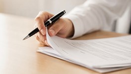 Professional trustee reviewing legal documents in a modern office