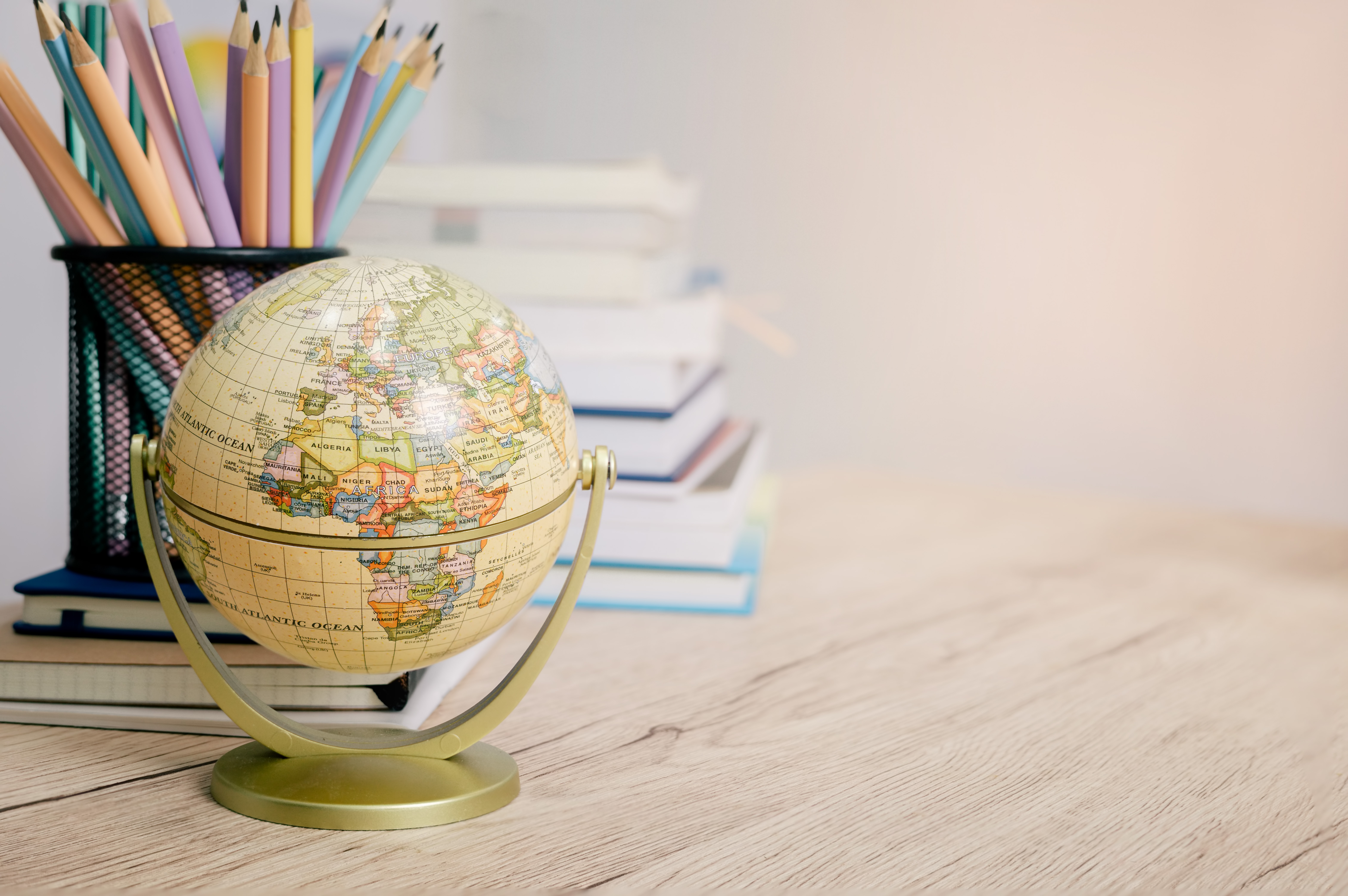 A desk with a globe and pencils