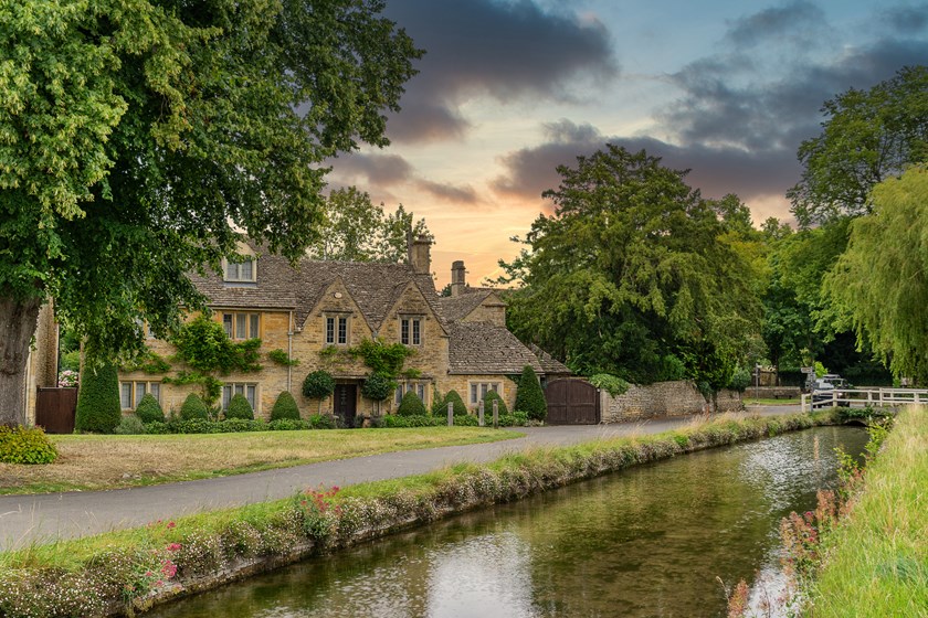 Cotswolds village scene near Lower Slaughter illustrating UK country house purchase and tax structuring considerations for non-resident buyers, including SDLT and ATED