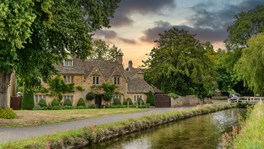 Cotswolds village scene near Lower Slaughter illustrating UK country house purchase and tax structuring considerations for non-resident buyers, including SDLT and ATED