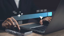 Smartphone and laptop displaying AI-powered search technology, illustrating Google's AI Overviews and new UK publisher controls introduced by the CMA.