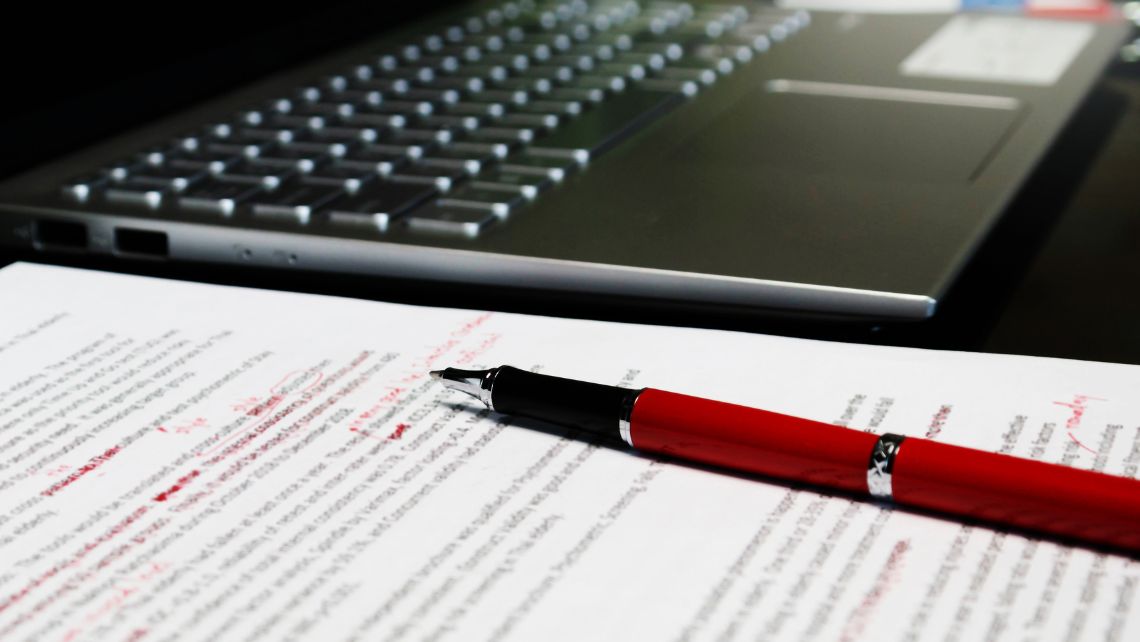 A blurred proofreading document on a table