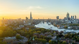 Aerial view of the City of London skyline at sunset, illustrating London's appeal as a destination for international investment, prime real estate and luxury assets.