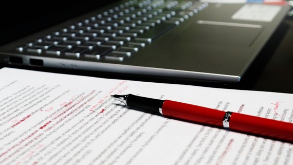 A blurred proofreading document on a table, symbolising the review and correction of errors in trust deeds.